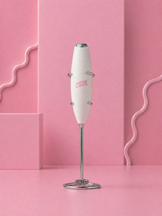White handheld blender with 'matcha love' branding on a pink background